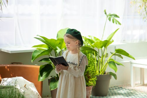 Photo of a Girl Reading a Book