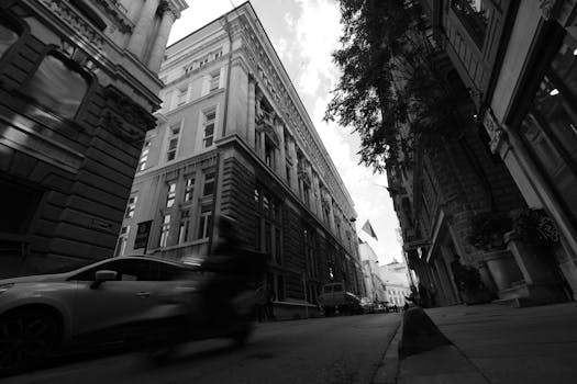 Black and white photo capturing the movement and architecture of Istanbul's historic city streets.
