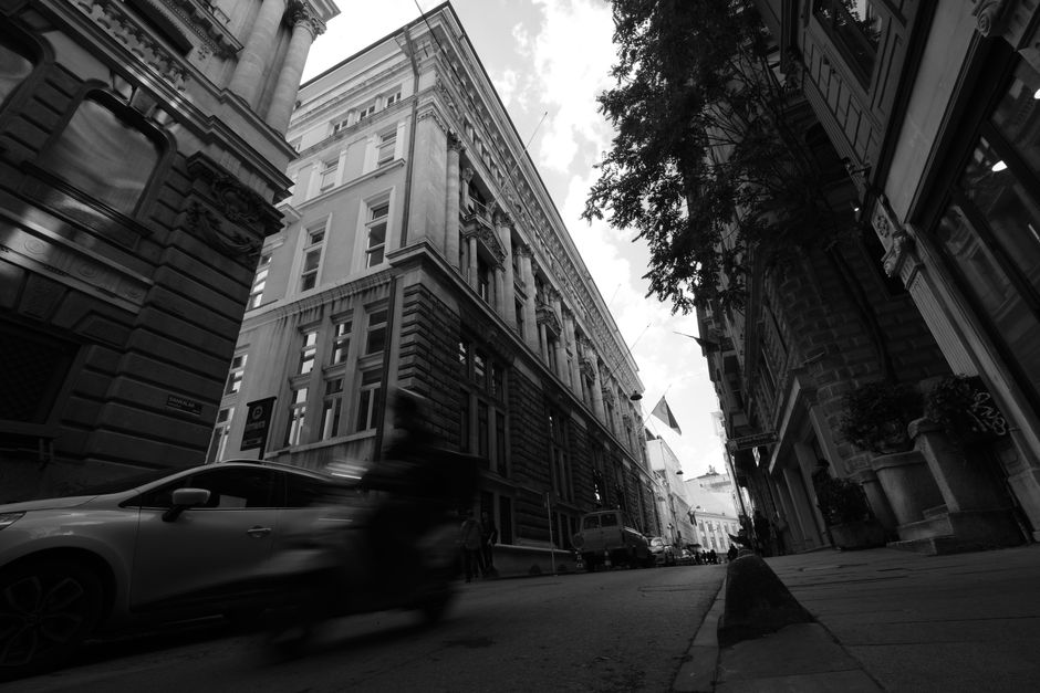 Black and white photo capturing the movement and architecture of Istanbul's historic city streets.