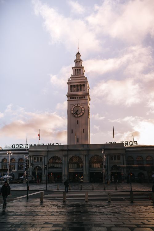 Free Ferry Building under a beautiful sunrise in San Francisco, showcasing architectural elegance. Stock Photo