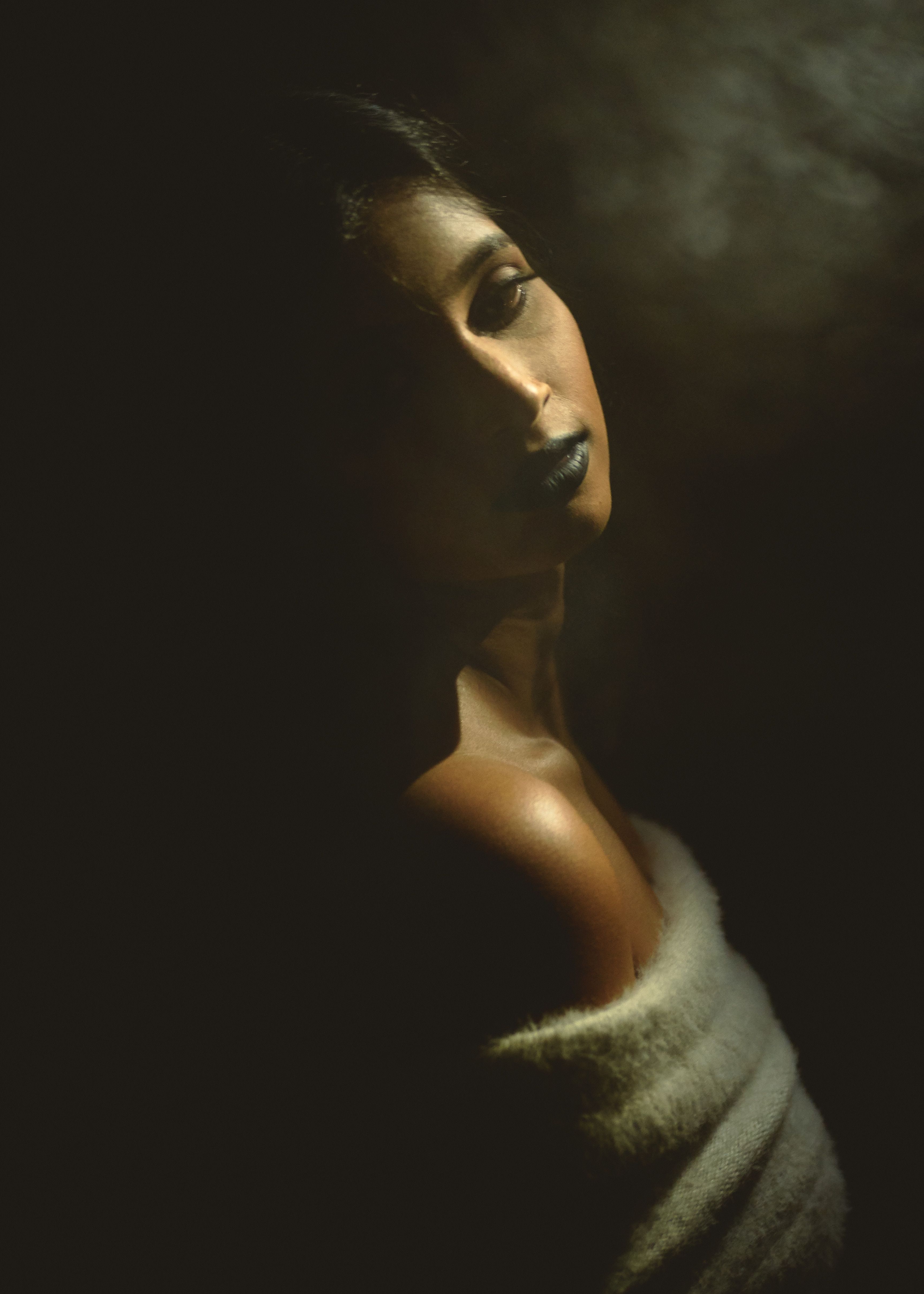 Atmospheric portrait emerging from shadow