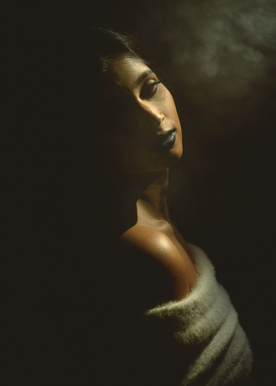 Atmospheric portrait emerging from shadow
