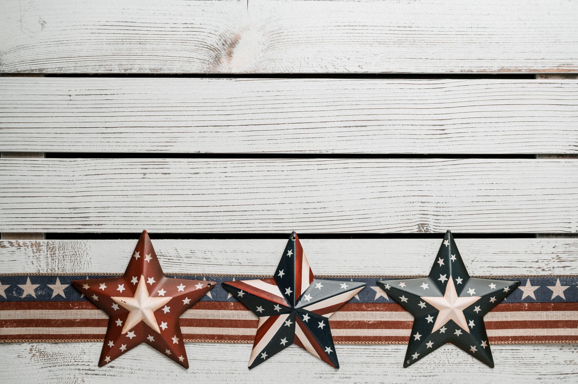 Top view of bright American decor with striped ribbons and stars representing purity and valor