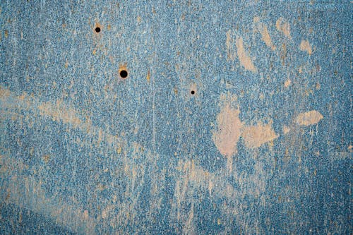 Old shabby metallic wall with tiny holes