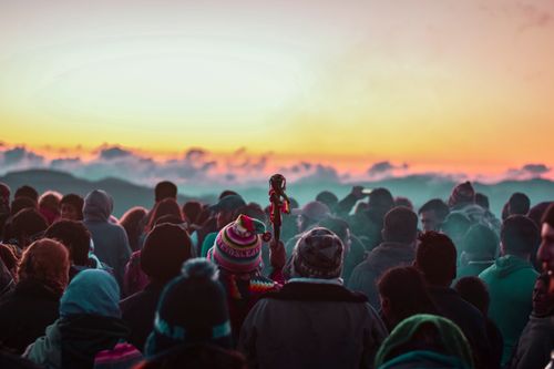 Free A colorful crowd gathers at sunset in Samaipata, Bolivia, against a stunning mountain backdrop. Stock Photo