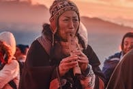 A Woman Crying while Playing Flute