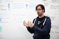 Man Standing in Front of a White Board