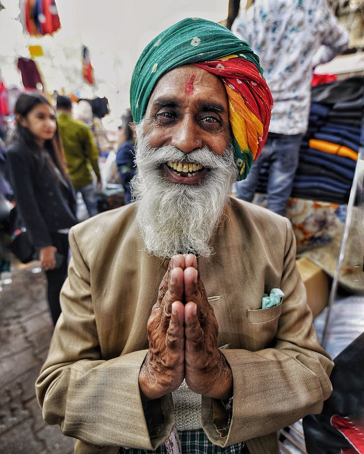 Happy Elderly Hindu Man With Prayer Hands On Street