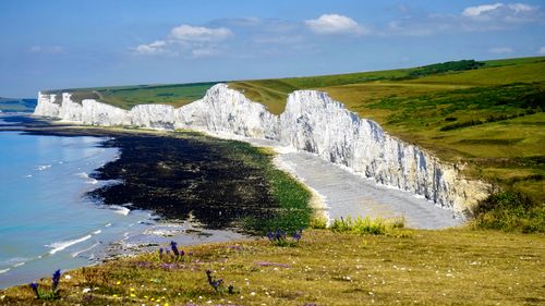 Free Scenic view of the iconic white cliffs of Seven Sisters, Sussex, with a tranquil seascape. Stock Photo