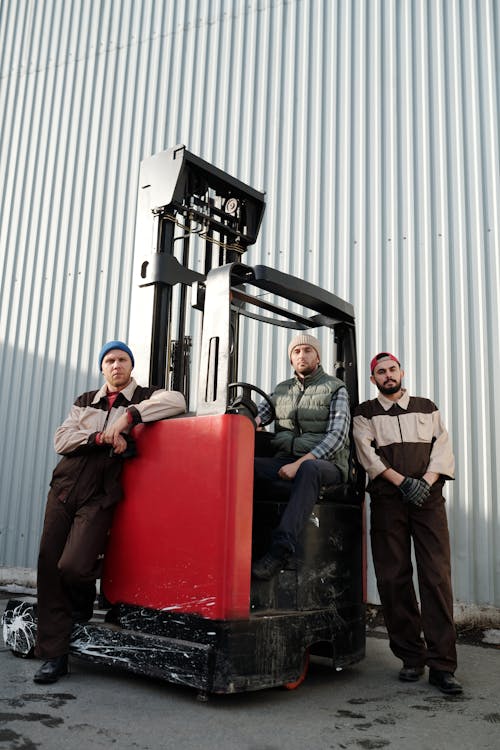 Free Employees Standing beside Forklift  Stock Photo