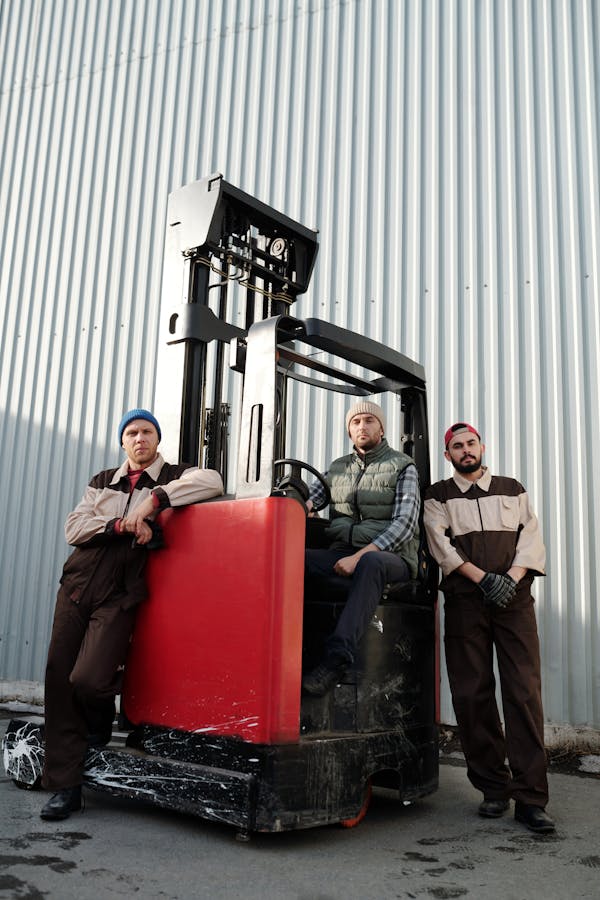 Employees Standing beside Forklift