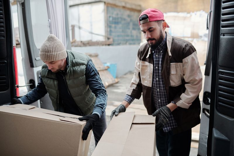 Two Sparrowgate crew members handling delivery boxes