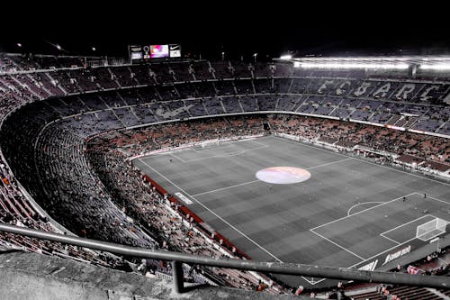 Modern football stadium with spectators on tribunes