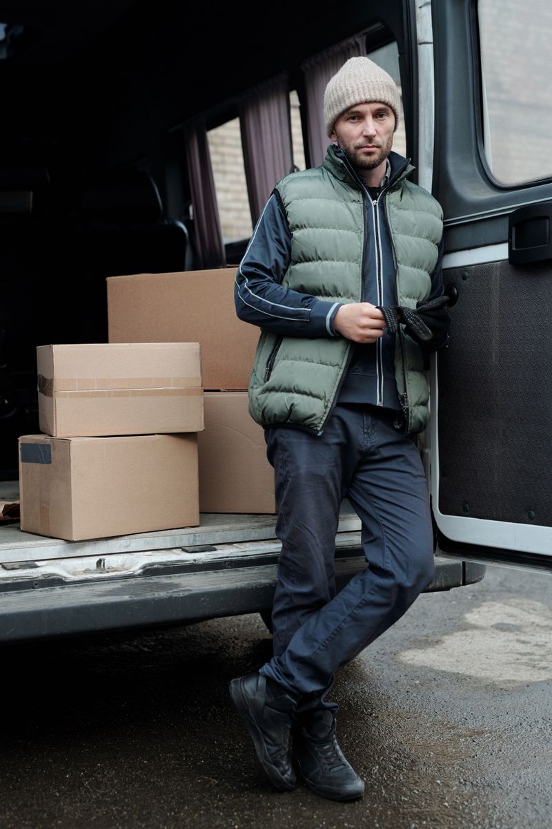 Delivery worker carrying a parcel to a customer's door