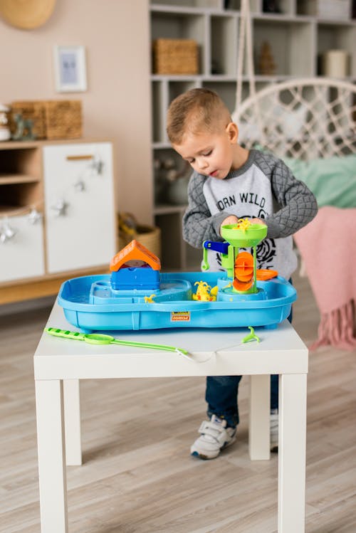 A Little Boy Playing Plastic Toys