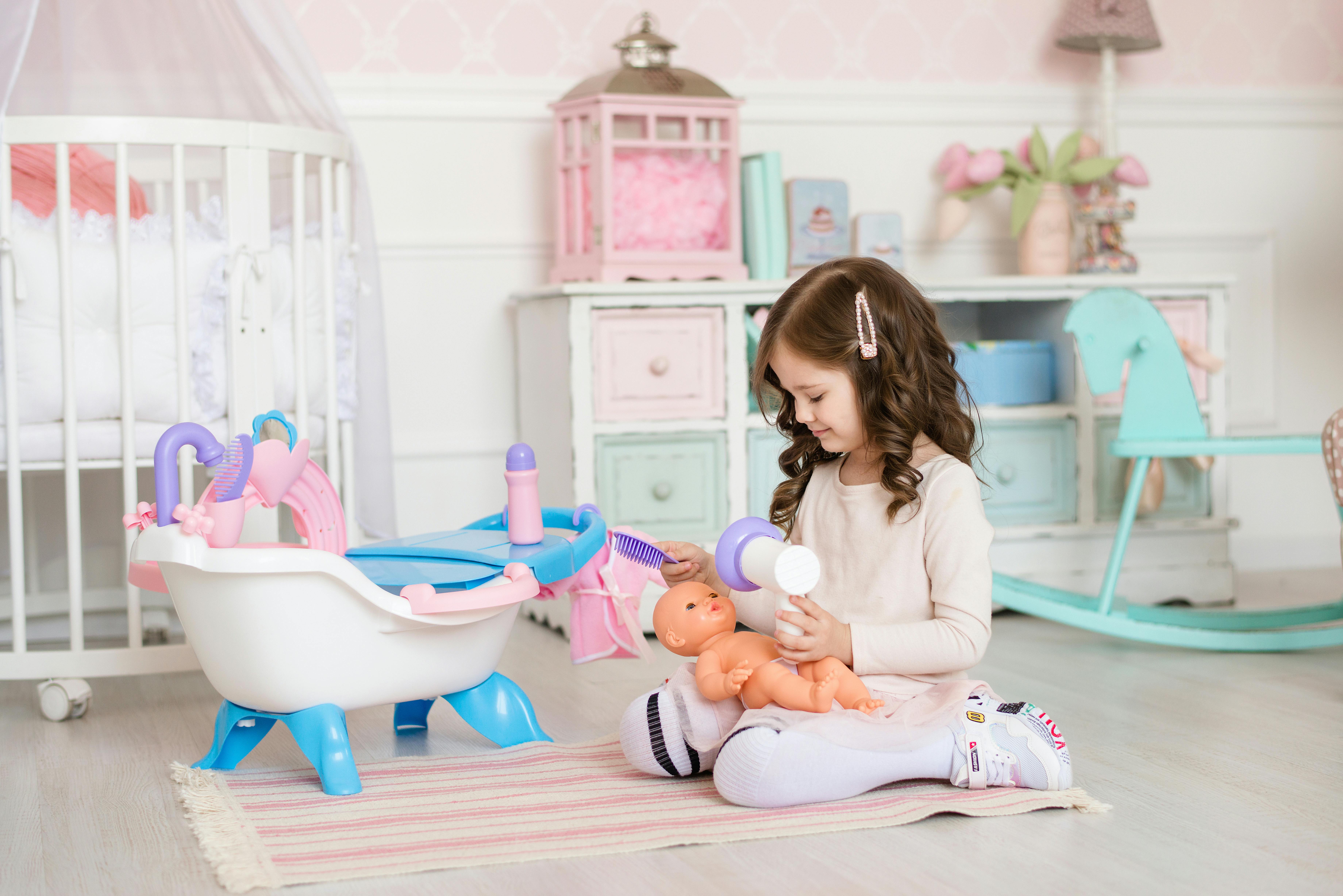 little girl playing with a doll