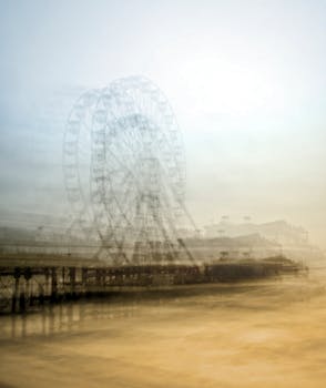 Abstract long exposure of a Ferris wheel at dusk, creating a dreamy, ethereal effect.