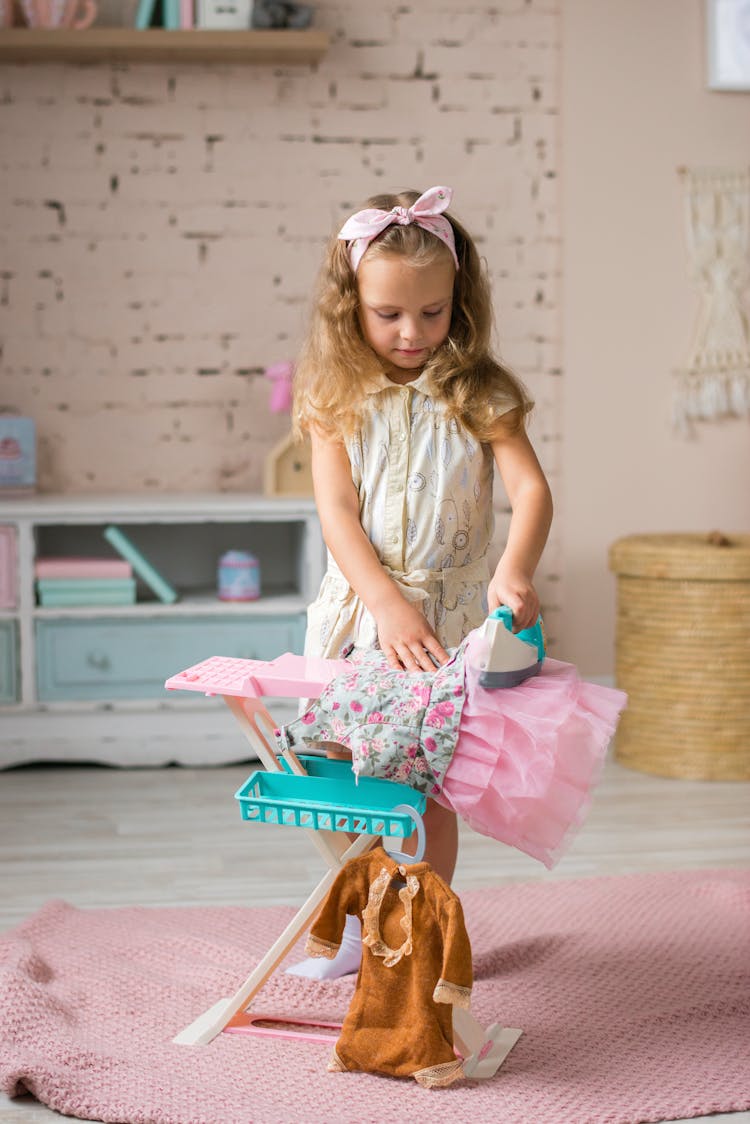 Girl Playing With An Ironing Board