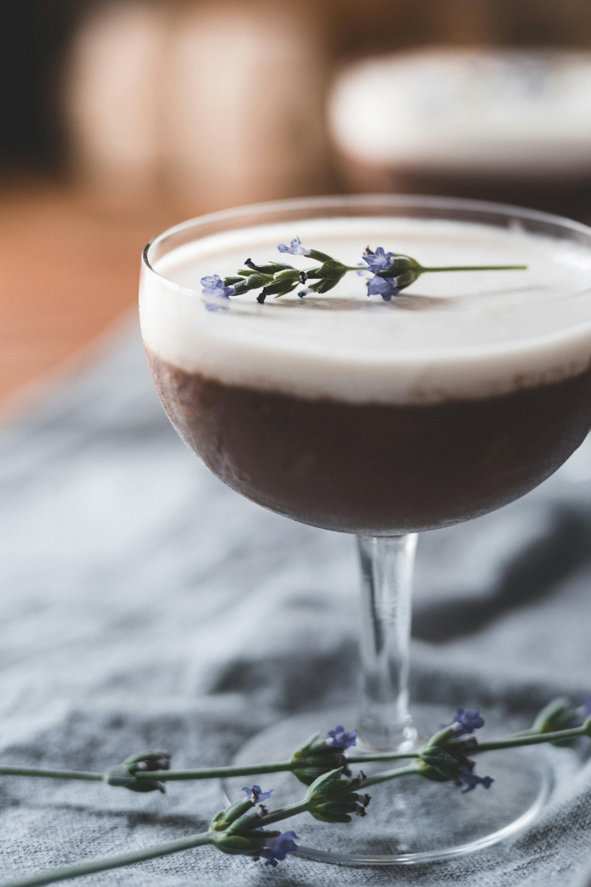 photo of chocolate dessert on a glass with lavender on top