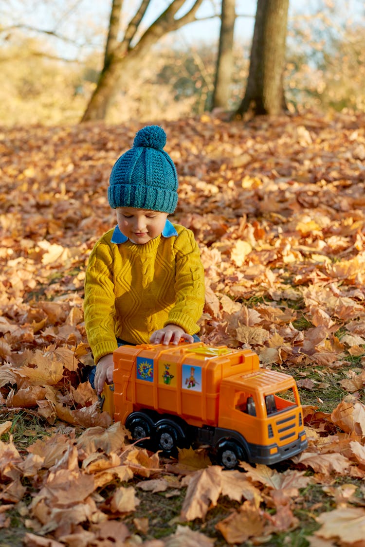 Boy Playing With A Toy Truck