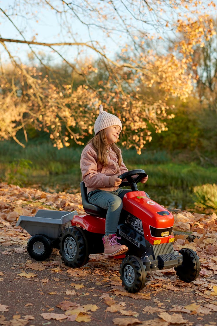 Girl Driving Toy Tractor 