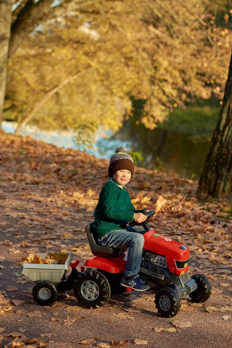 A Boy Riding An ATV Toy