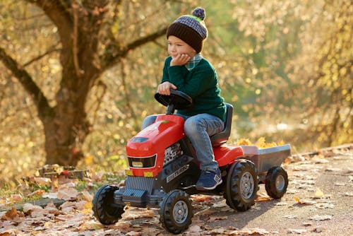 Free Boy in Blue Jacket Riding Red and Black Atv Stock Photo