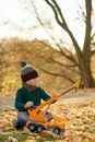 Boy Playing Guitar Sitting on Ground