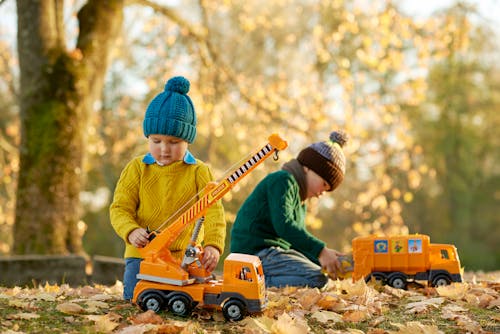 Free Kids Playing with Toy Trucks Stock Photo