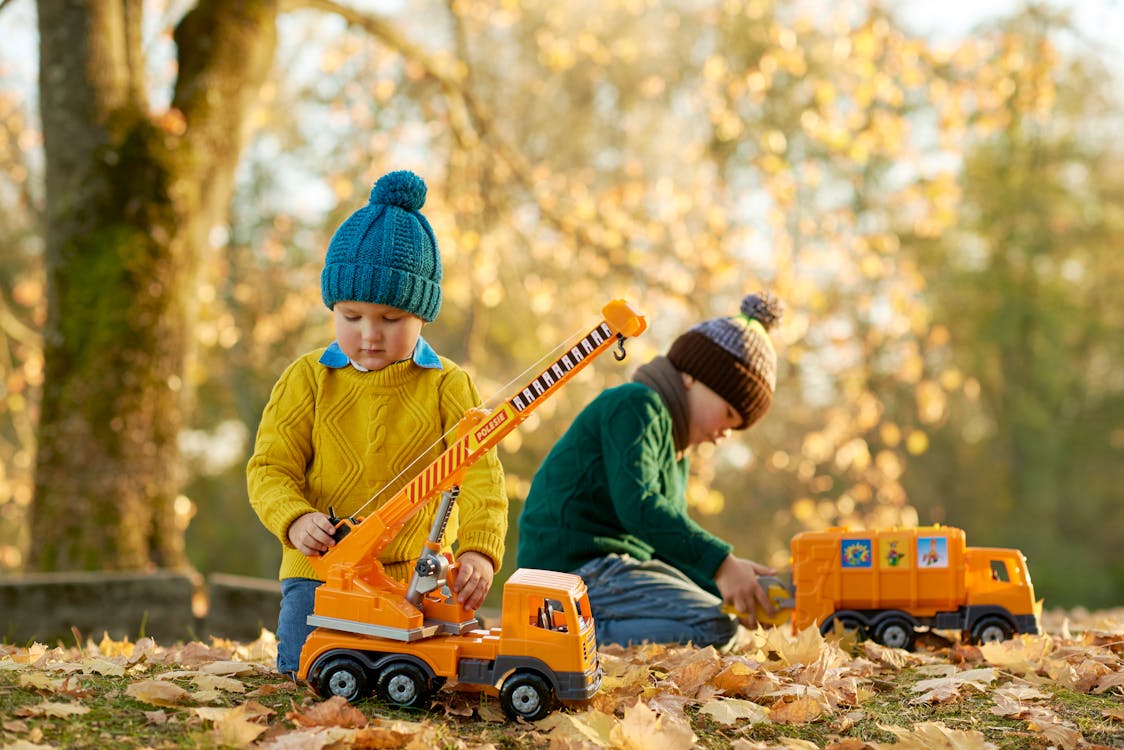 Toddlers playing with hot sale trucks