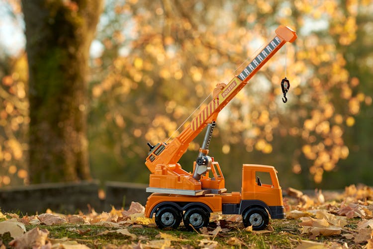 Plastic Construction Truck Toy On Autumn Ground