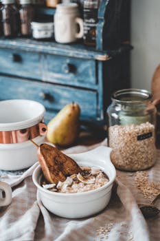 Charming rustic breakfast setup featuring oatmeal with pear and vintage kitchen decor.