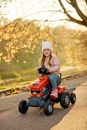 Woman in Beige Hijab Riding Red Atv