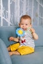 A Child Holding a Rattle Plastic Toy