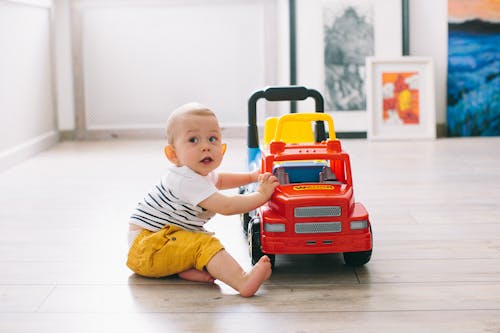 Toddler Playing with a Toy Car