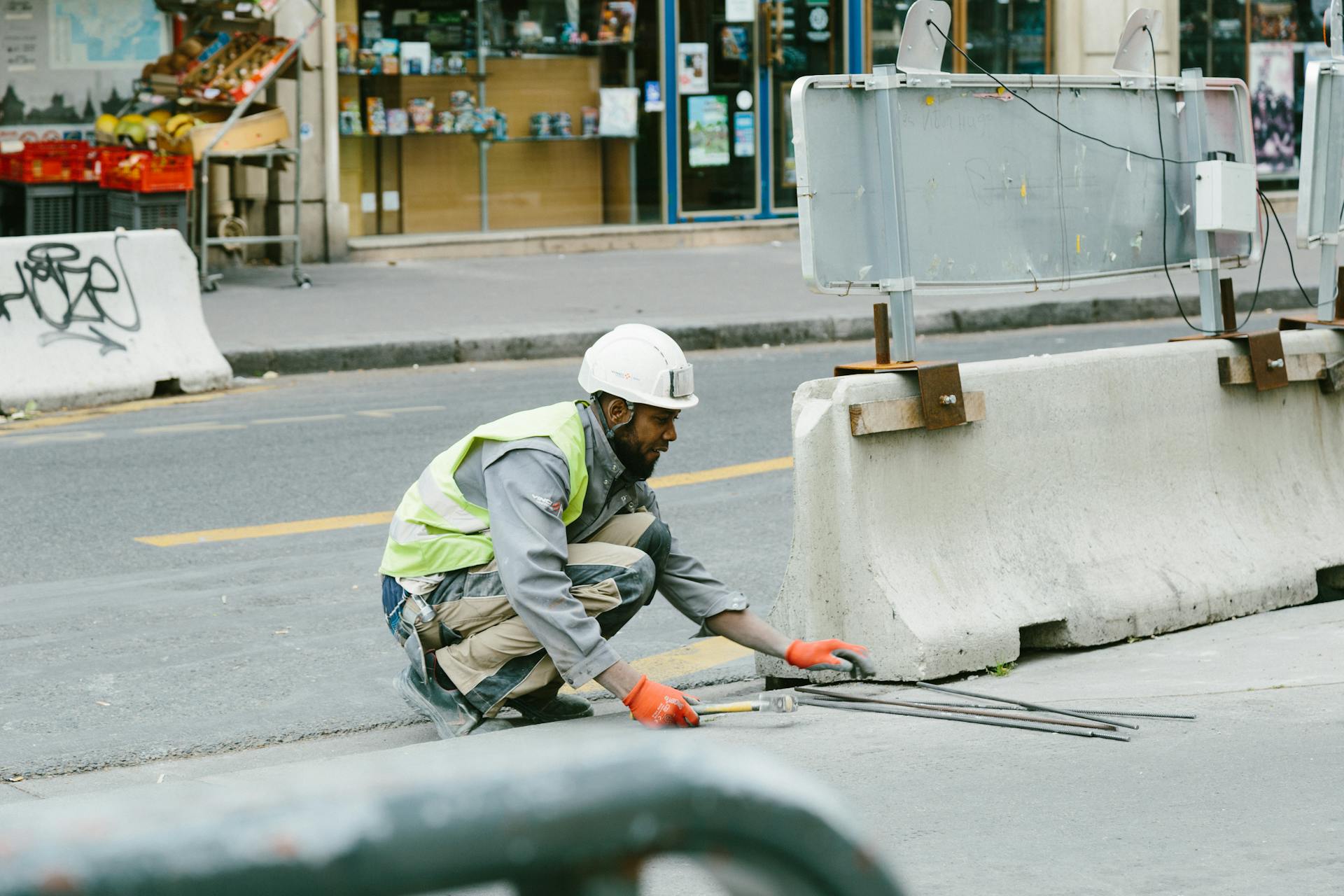 A construction worker operates on a city street in Paris, France, showcasing urban development.