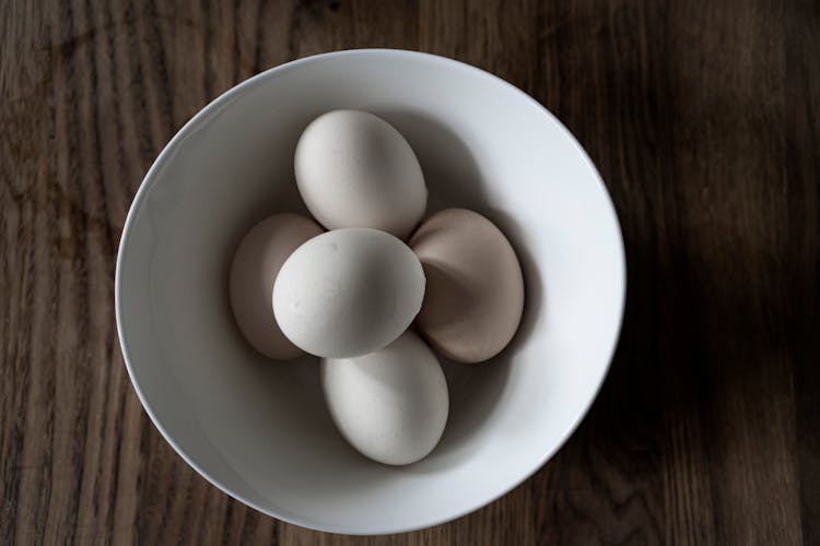 White Raw Eggs In Bowl On Table