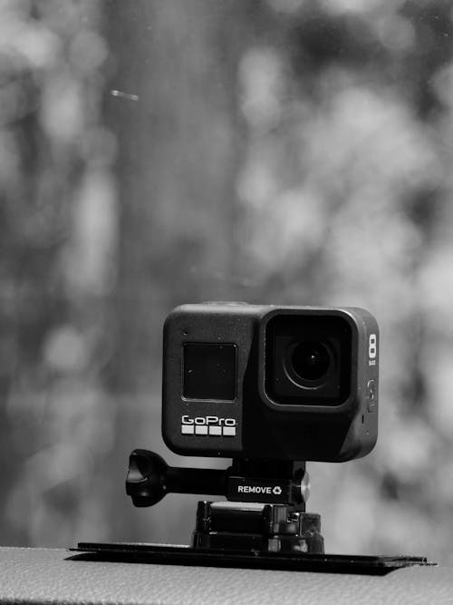 Contemporary compact action camera on stand outdoors