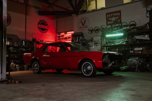 Red Vintage Car Parked in Front of Store