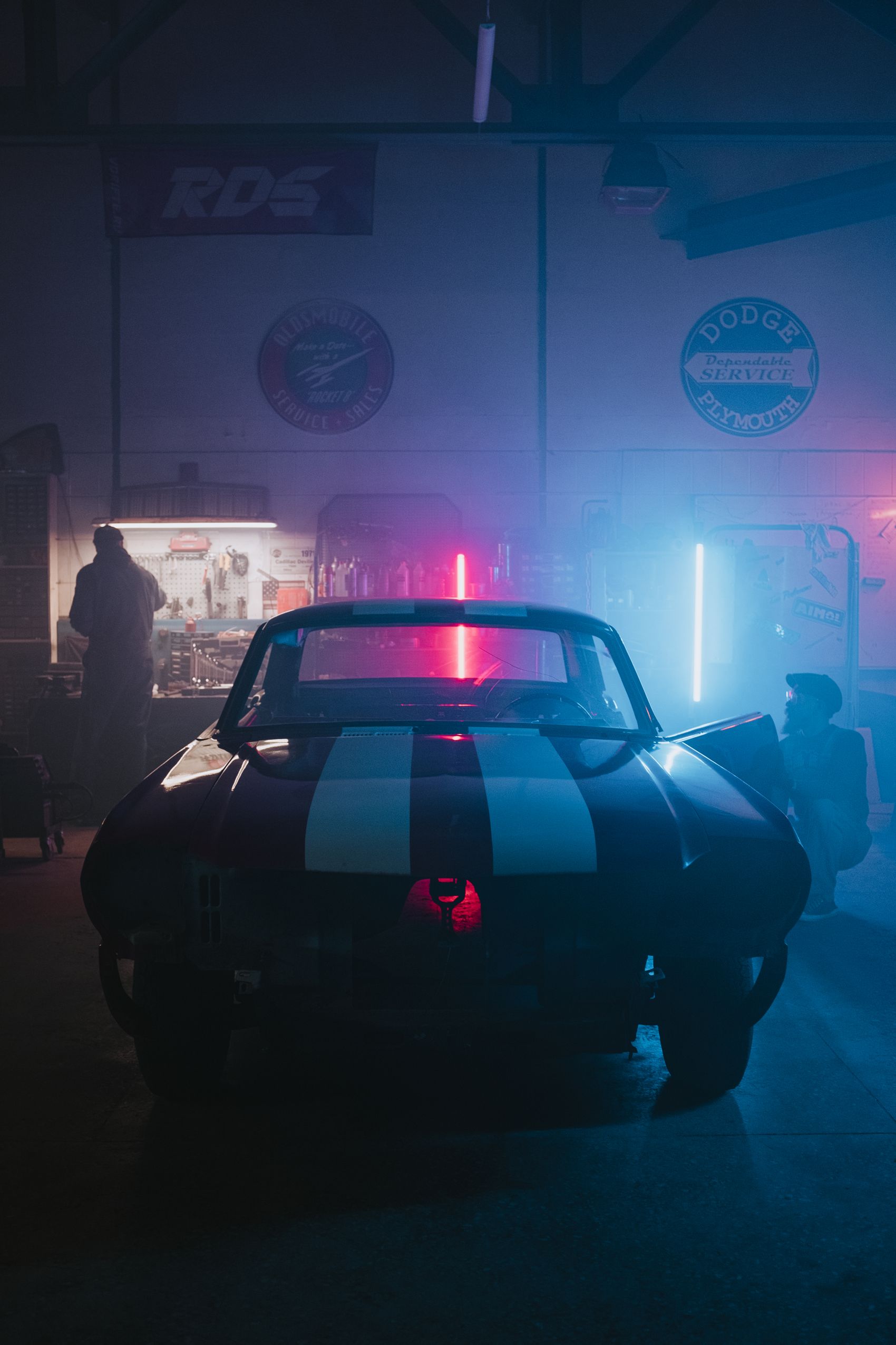Professional automotive workshop prepared for vehicle electronics installation and testing