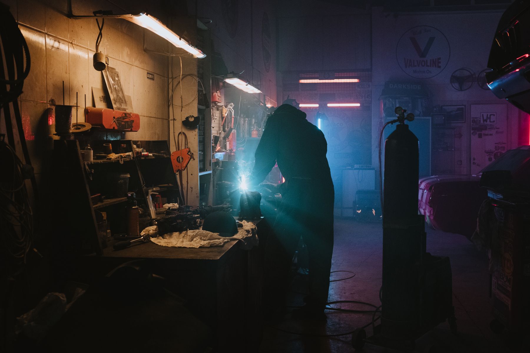 Mechanic using automotive diagnostic equipment in a repair workshop
