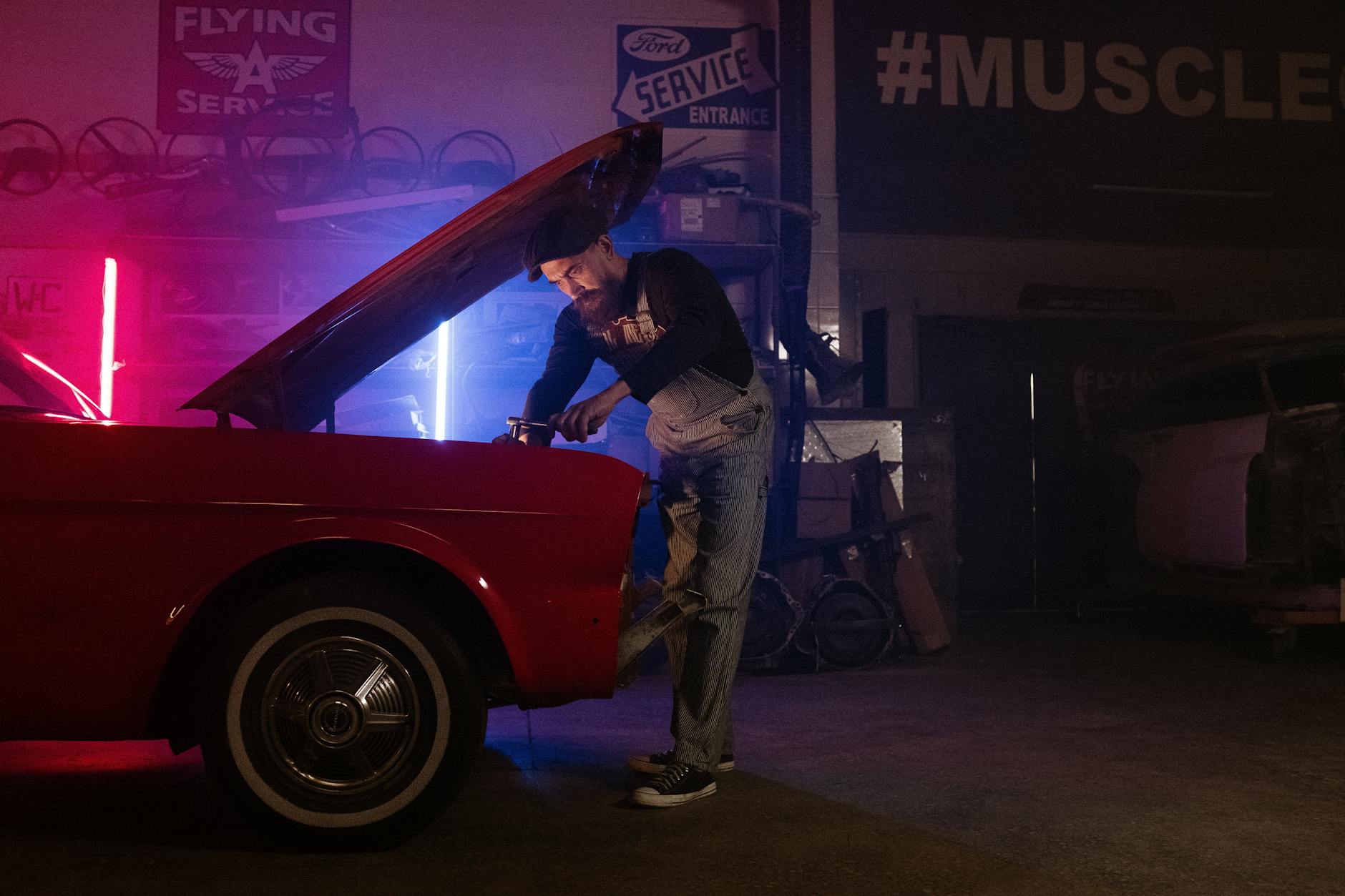 https://www.pexels.com/photo/man-in-black-jacket-and-blue-denim-jeans-leaning-on-red-car-4488656/