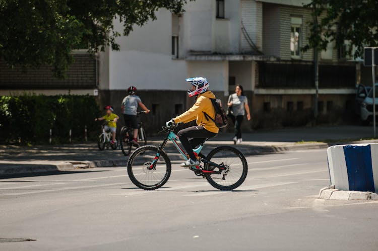 Unrecognizable Biker Riding Bicycle On City Road