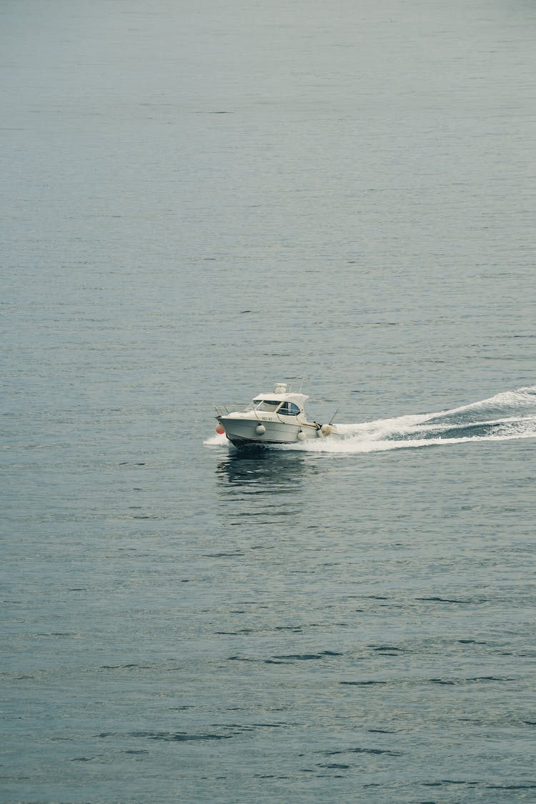 Fast Motor Boat Sailing On Ocean In Afternoon