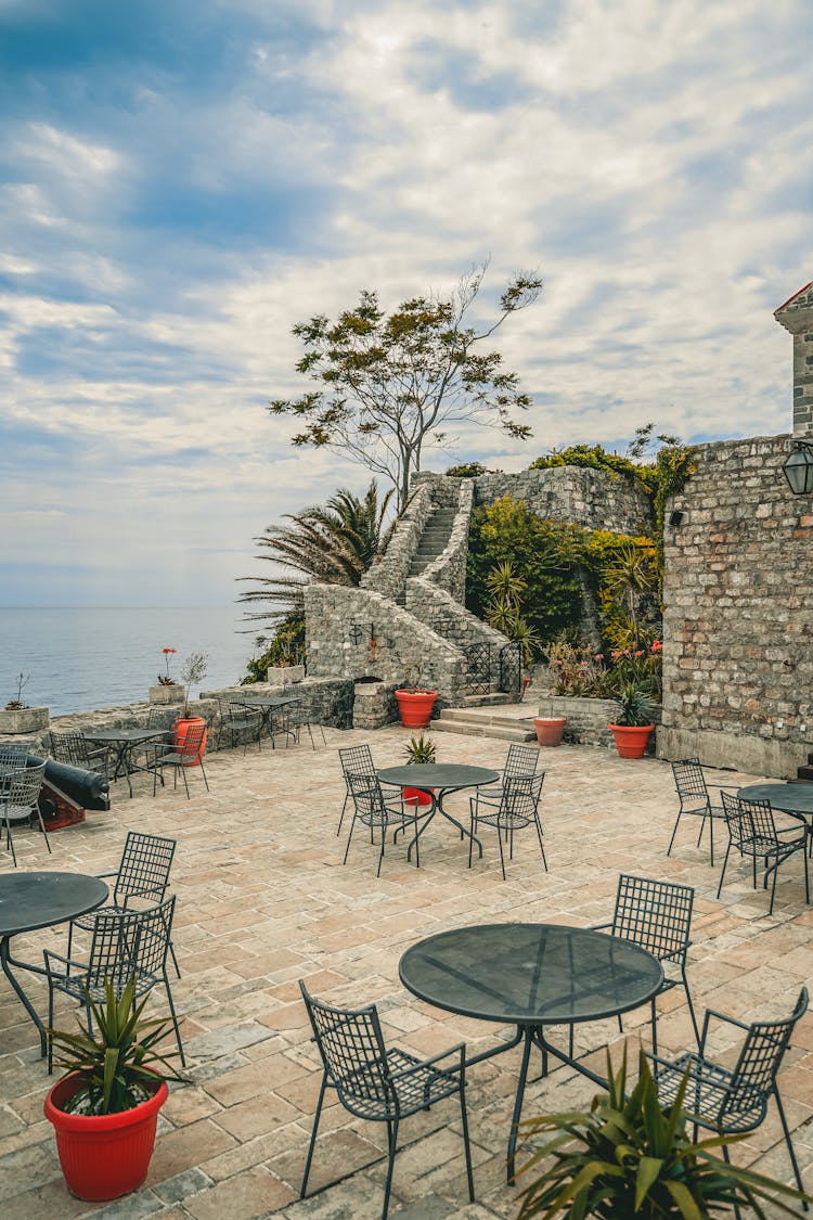 Cafe Interior On Old Terrace Near Ocean Under Cloudy Sky