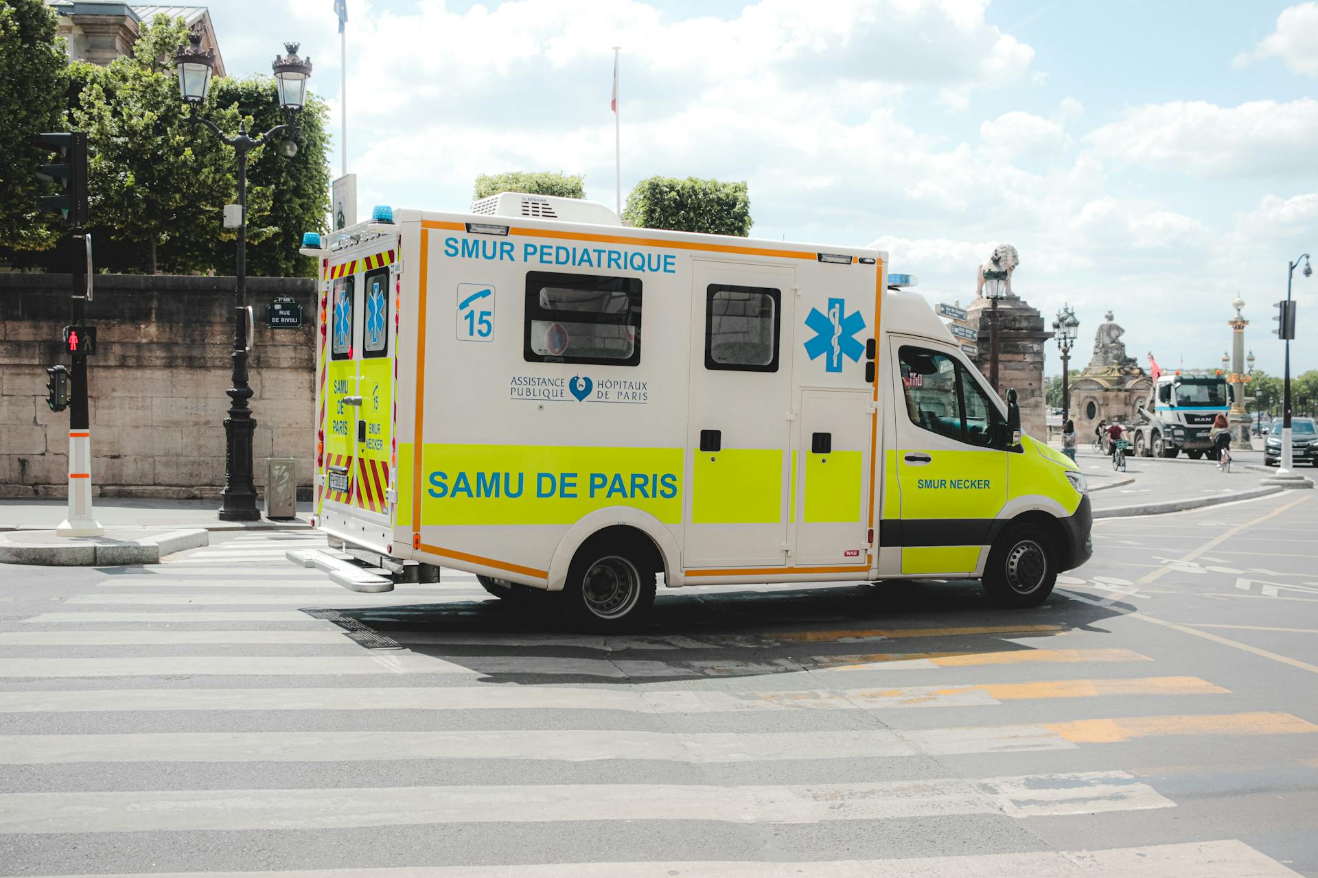 Pediatric ambulance navigating through Paris city streets, highlighting emergency healthcare services.