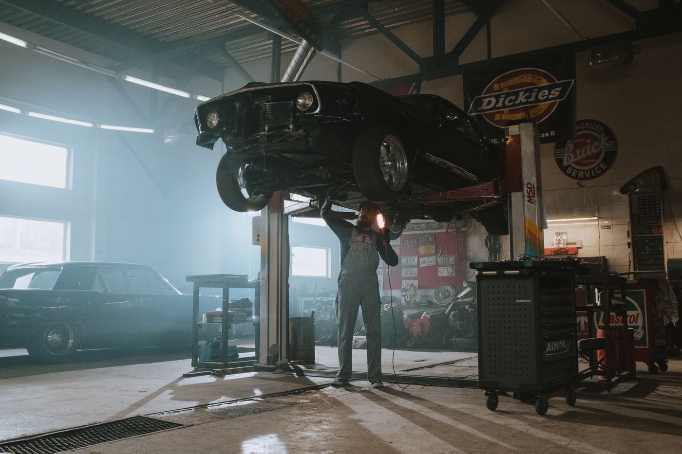 Technician performing computerized tire and wheel balancing