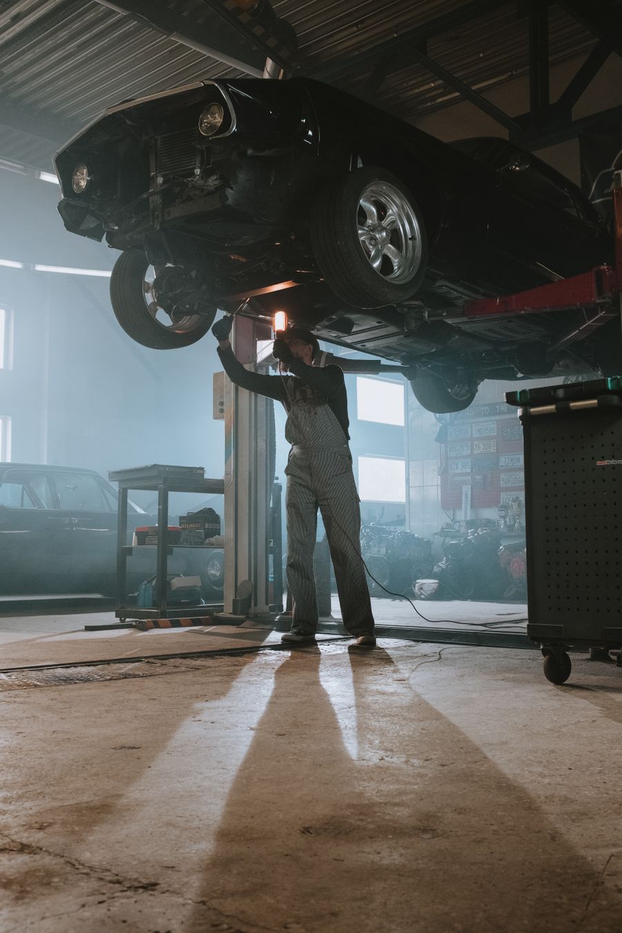 Technician working underneath a vehicle