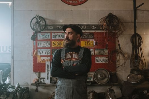 Man in Black and Red Pullover Hoodie Standing Near Red and Black Wall
