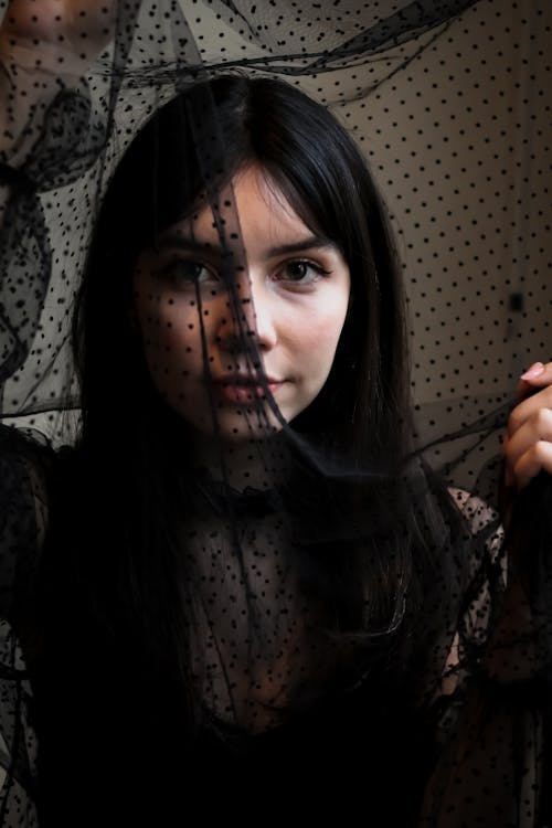 Woman Holding a Black Polka Dot Sheer Fabric